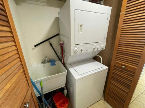 a small kitchen with a sink and a white refrigerator at 506 Ocean & Marina Views 3 Bedroom 2 Bathroom Lux in Fajardo