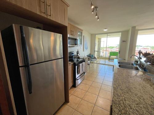 a kitchen with a large stainless steel refrigerator at 506 Ocean & Marina Views 3 Bedroom 2 Bathroom Lux in Fajardo