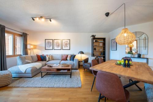 a living room with a couch and a table at No 8 Bed & Bar in Verbier