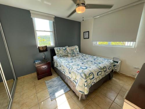 a bedroom with a bed and two windows at 506 Ocean & Marina Views 3 Bedroom 2 Bathroom Lux in Fajardo
