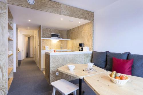 un salon avec un canapé et une table dans l'établissement Résidence Aiguille Rouge - Centre station Appartement 3 pièces 8 personnes MAE-4634, à Arc 2000