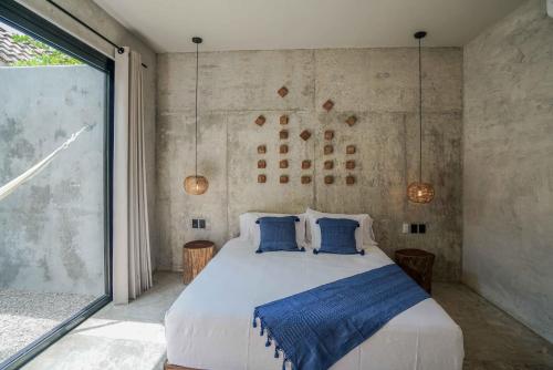 a bedroom with a large bed with blue pillows at Witari Hotel Boutique in San Francisco