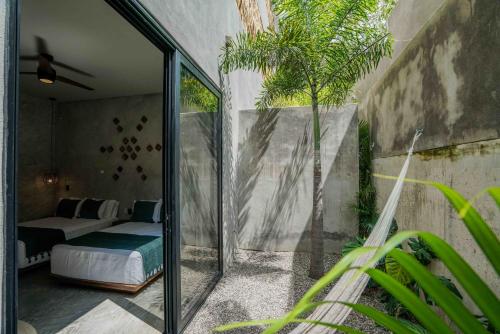 a room with a bed and a glass door at Witari Hotel Boutique in San Francisco