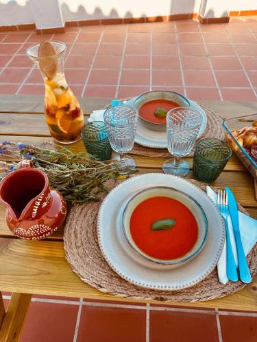 a table with two plates of soup on it at Casa do Castelo in Belver