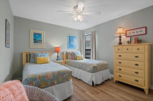 a bedroom with two beds and a dresser at Cotton Bayou Unit 4E in Orange Beach