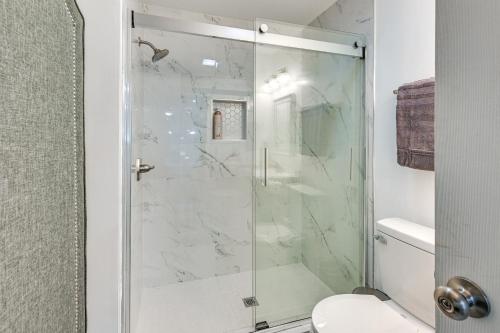 a shower with a glass door in a bathroom at Home with Hot Tub, Playset and Grills in Clarksville! in Clarksville