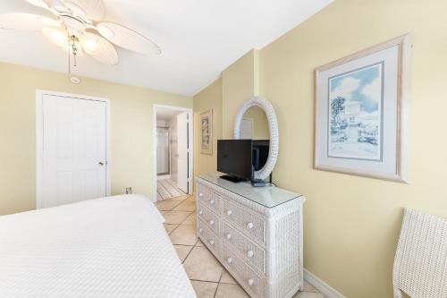 a bedroom with a bed and a tv on a dresser at Royal Palms Unit 1205 in Gulf Shores