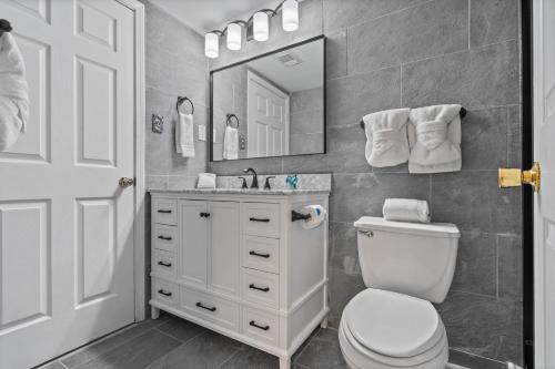 a bathroom with a toilet and a sink and a mirror at Royal Palms Unit 1205 in Gulf Shores