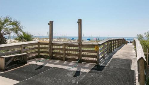 a wooden walkway to the beach with a wooden fence at Royal Palms Unit 1205 in Gulf Shores