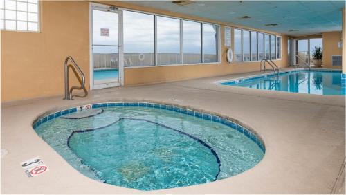 a large swimming pool in a hotel room with a large pool at Royal Palms Unit 1205 in Gulf Shores