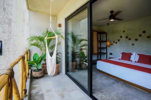 a bedroom with a bed and some potted plants at Witari Hotel Boutique in San Francisco