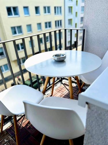 a small white table and chairs on a balcony at Apartment-City in Cologne