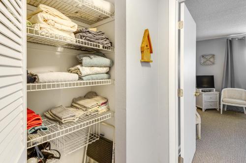 a walk in closet with white shelves and towels at Walk to Pool Riverfront Welaka Condo with Boat Ramp in Welaka