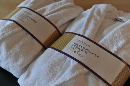 a book sitting on top of a towel at Mercure Maurepas Saint Quentin in Maurepas