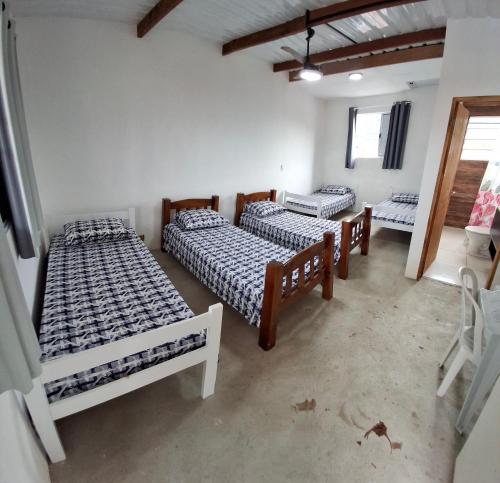 Postel nebo postele na pokoji v ubytování Suíte Sonho Real Perequê Açu