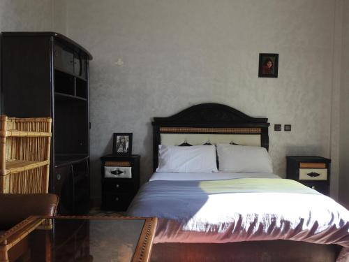 a bedroom with a large bed and two night stands at Imsouane Surf Slab Hostel in Imsouane