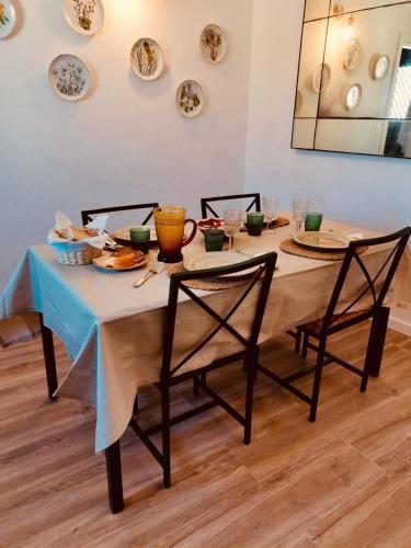 a dining room table with a blue table cloth and chairs at Casa do Castelo in Belver