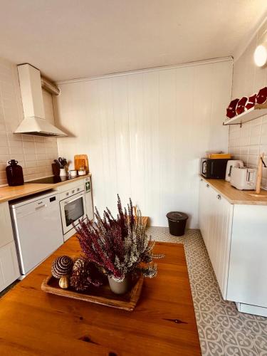 a kitchen with a wooden table in a kitchen at Casa do Castelo in Belver