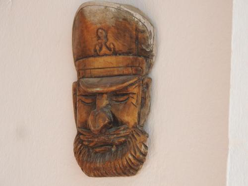 a wooden mask hanging on a wall at Imsouane Surf Slab Hostel in Imsouane
