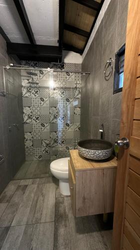 a bathroom with a sink and a toilet and a shower at Moderna casa campestre in Guamo