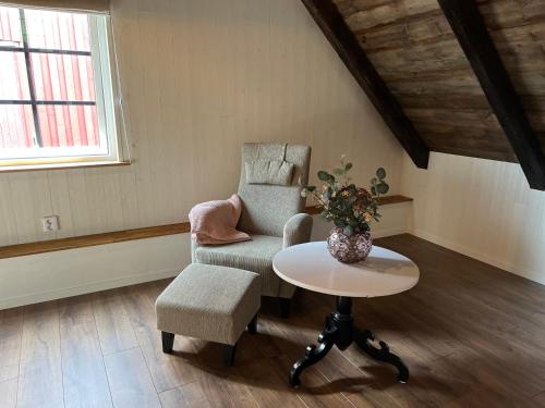 a living room with a chair and a table at Lovely Home With Sauna in Svalöv