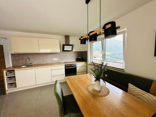 a kitchen with a wooden table and a dining room at Urlaub am Bauernhof in Karrösten