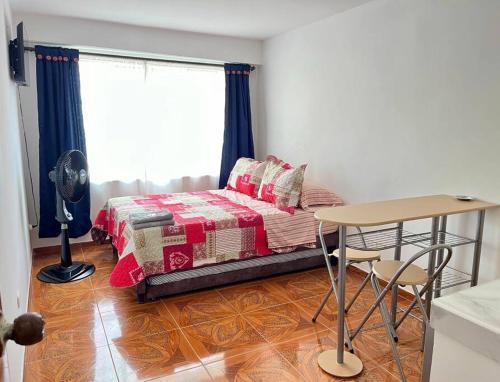 En eller flere senge i et værelse på Central Aparta-estudio Pereira