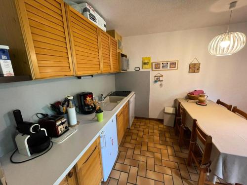 a kitchen with a table and a counter top at Résidence Gardiole 4 - Appartement spacieux · Proche des pistes · Wifi gratuit & proche des Grands Bains MAE-0234 in Le Monêtier-les-Bains