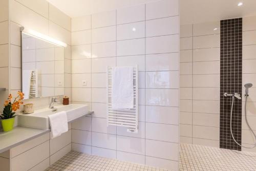 une salle de bain blanche avec un lavabo et une douche dans l'établissement Résidence Signal Du Prorel - Appartement spacieux · Accès direct aux pistes · Wifi gratuit · Terrasse MAE-0374, à Briançon