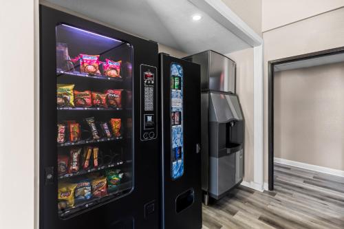 a black refrigerator with food and drinks in a room at Quality Inn Oskaloosa in Oskaloosa