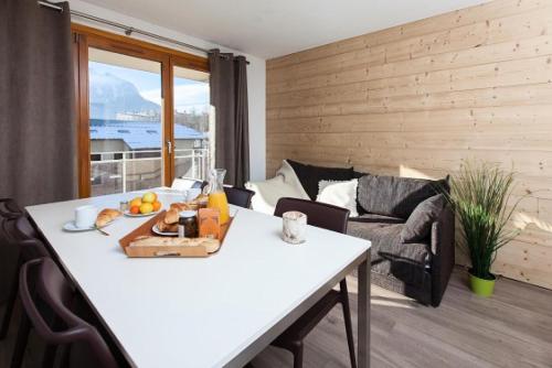 - un salon avec une table et des fruits dans l'établissement Résidence Signal Du Prorel - Appartement entièrement rénové · Au pied des pistes · Casier à skis & wifi gratuit MAE-0454, à Briançon