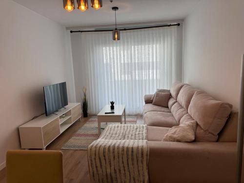 a living room with a couch and a television at Rivas Futura in Rivas-Vaciamadrid