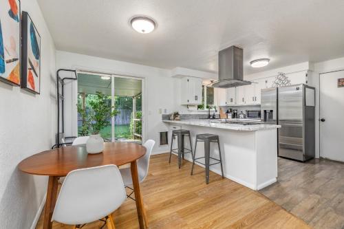 a kitchen and dining room with a table and chairs at Cozy Boise Home with Private Yard and Game Room in Boise