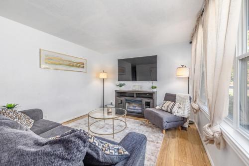 a living room with two couches and a tv at Cozy Boise Home with Private Yard and Game Room in Boise