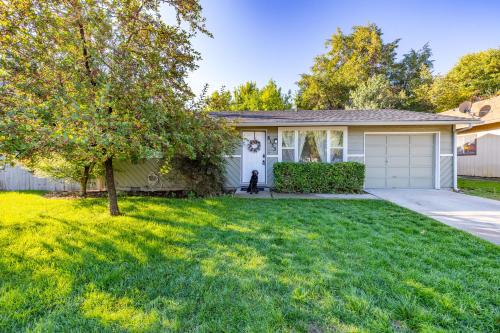 a house with a dog in a yard at Cozy Boise Home with Private Yard and Game Room in Boise