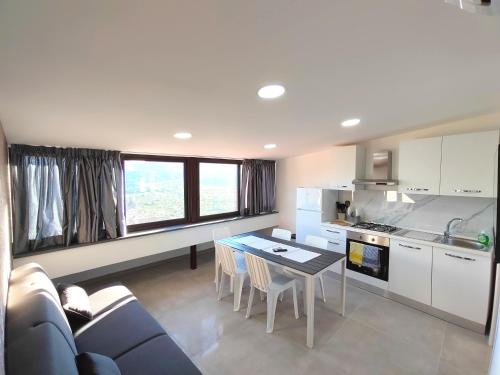 a kitchen and living room with a couch and a table at Casa Borgo Antico Cavallaro in Gaggi