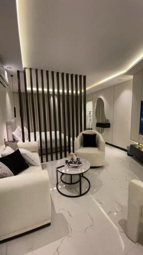 a living room with two white couches and a table at Modern studio Self entry in Riyadh