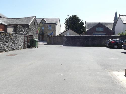 a parking lot with a car parked in a driveway at Plas Coch Hotel Ltd in Bala