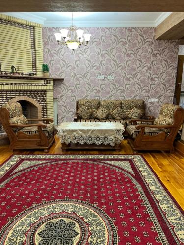 a living room with a couch and a fireplace at Elite comfort City house in Samarkand