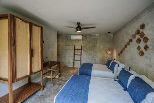 a bedroom with two beds and a desk and a ladder at Witari Hotel Boutique in San Francisco