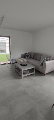 a living room with a couch and a coffee table at Nowa Osada in Łącko