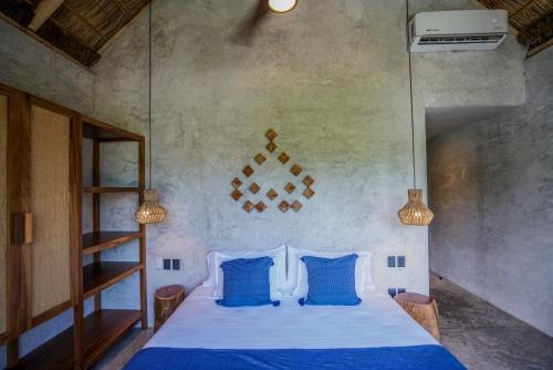 a bedroom with a bed with blue pillows at Witari Hotel Boutique in San Francisco