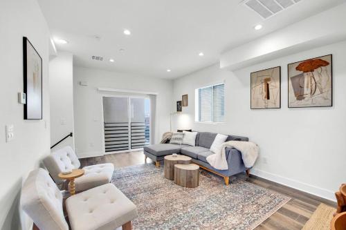 a living room with a couch and two chairs at Luxe Townhouse Near Downtown LA in Los Angeles