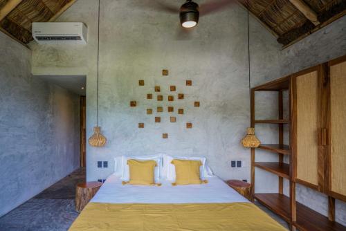 a bedroom with a large bed with yellow pillows at Witari Hotel Boutique in San Francisco
