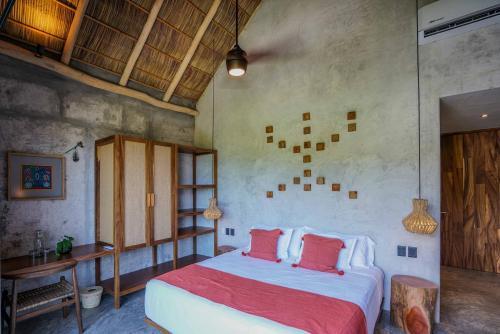 a bedroom with a large bed with red pillows at Witari Hotel Boutique in San Francisco