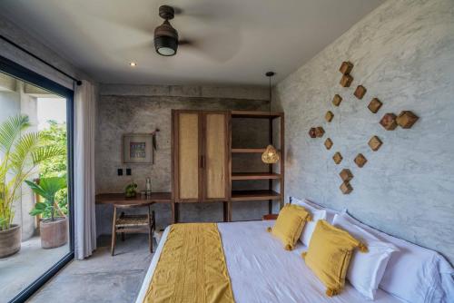 a bedroom with a large bed with yellow pillows at Witari Hotel Boutique in San Francisco
