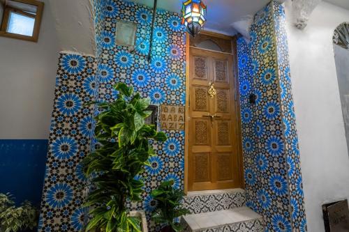 a room with blue and white tiles on a door at Dar baba Aziz La perle de la Médina in Tangier