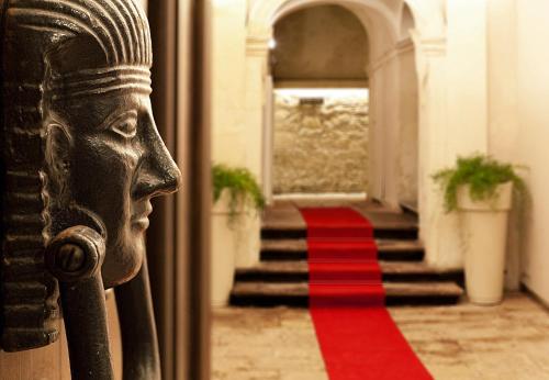a door with a red carpet in front of a stairway at Hotel Vittorio Veneto in Ragusa