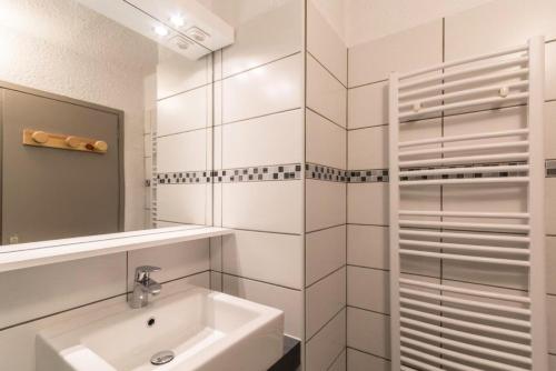 une salle de bain blanche avec un lavabo et un miroir dans l'établissement Les Chalets De La RosiÈre - Studio de 25m² pour 4 personnes MAE-8004, à Montvalezan