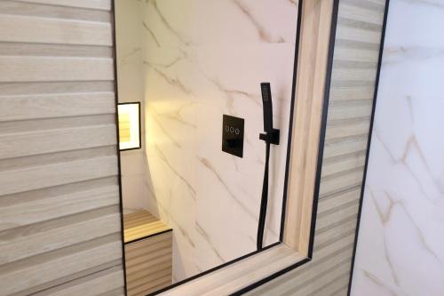 a glass door with a mirror in a hallway at Las Terrazas de la Provi, Mejores Vistas in Gijón